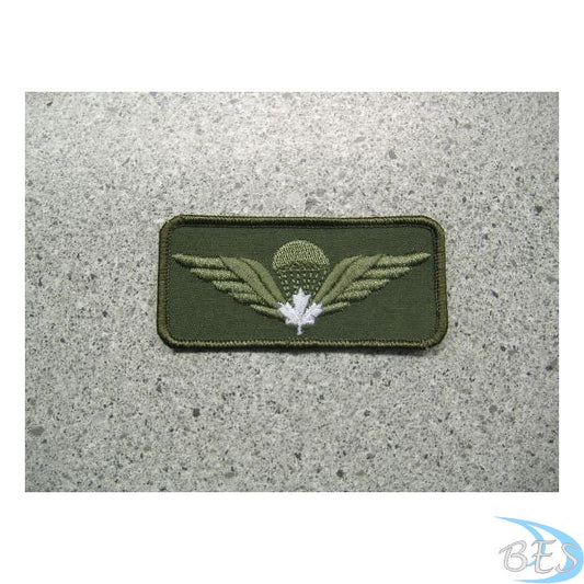 Airborne wings with white maple leaf on olive drab